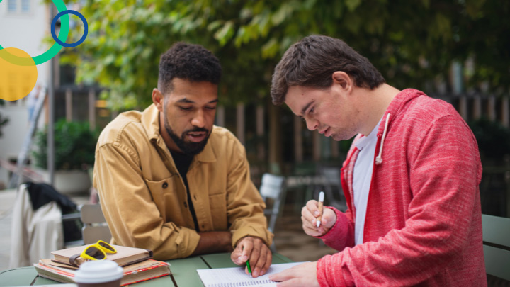 Man helping student with writing
